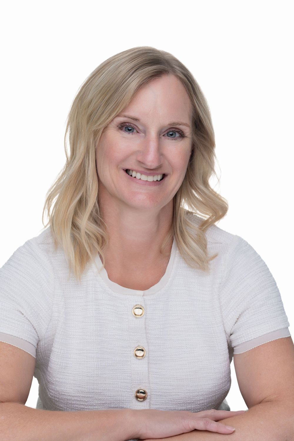 Professional headshot series showing warm smiles and white top against light background.