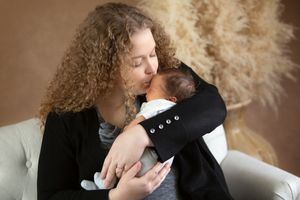 Intimate lifestyle photography session with natural light and pampas grass decor.