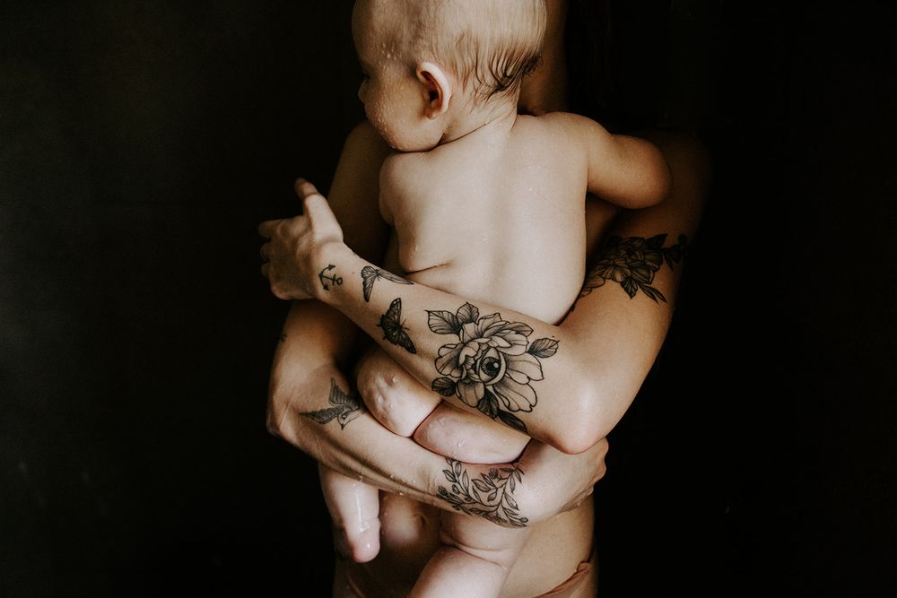 Close-up artistic black and white photos showing hands with tattoos and rings in various intimate poses.