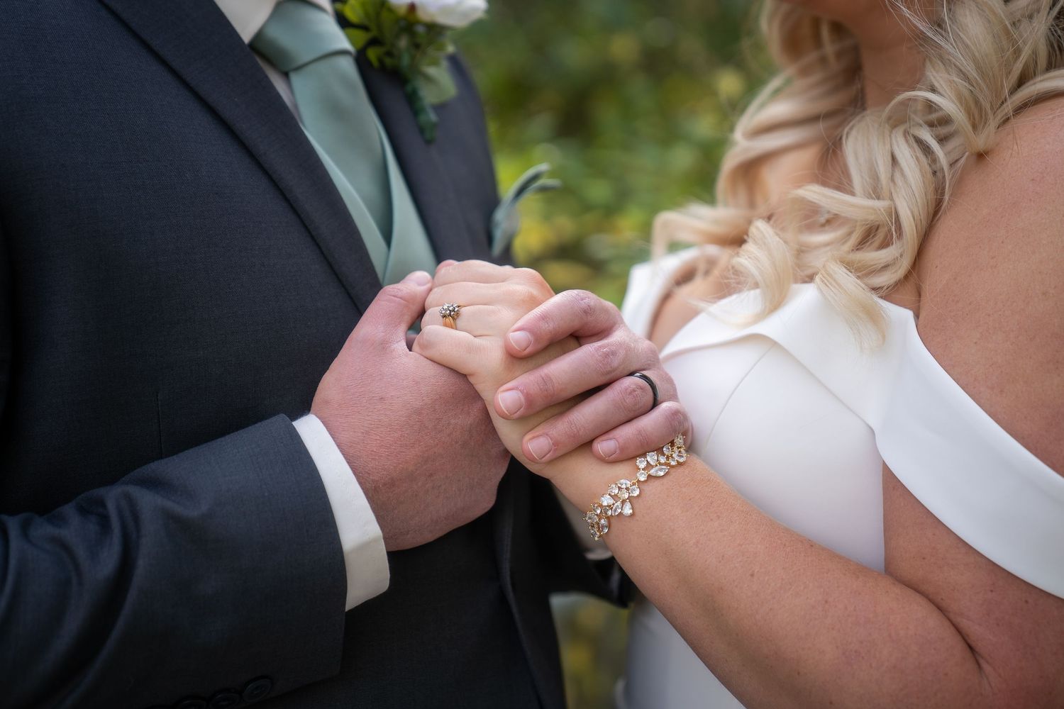 A series of romantic wedding photos showing close-up shots of hands and rings during an outdoor ceremony.