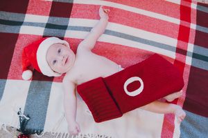 Red and white plaid fabric pattern with soft folds creates a classic textile background texture.
