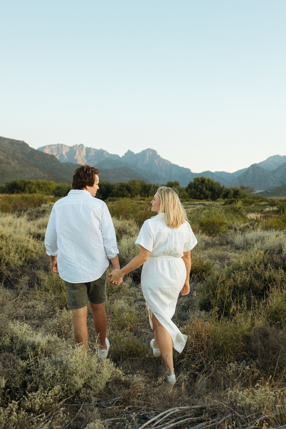 couple walking in the field in Franschhoek.