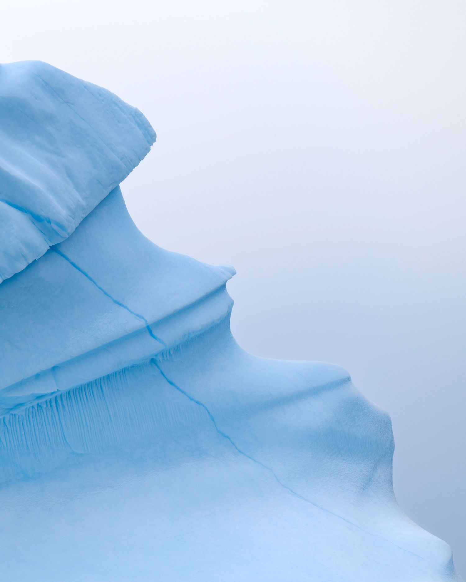 Minimalist abstract landscape of smooth blue ice formations against a white background.