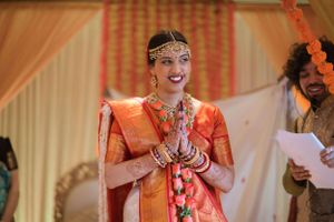 Escentric newly wed finishing her Vivāha portraying an outburst of emotions towards the photographers camera