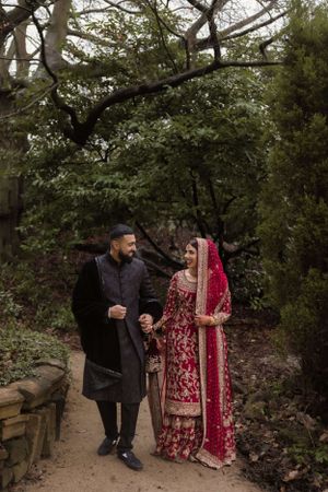 utterly dedicated couple grinning following their Anand karaj and posing for the camera