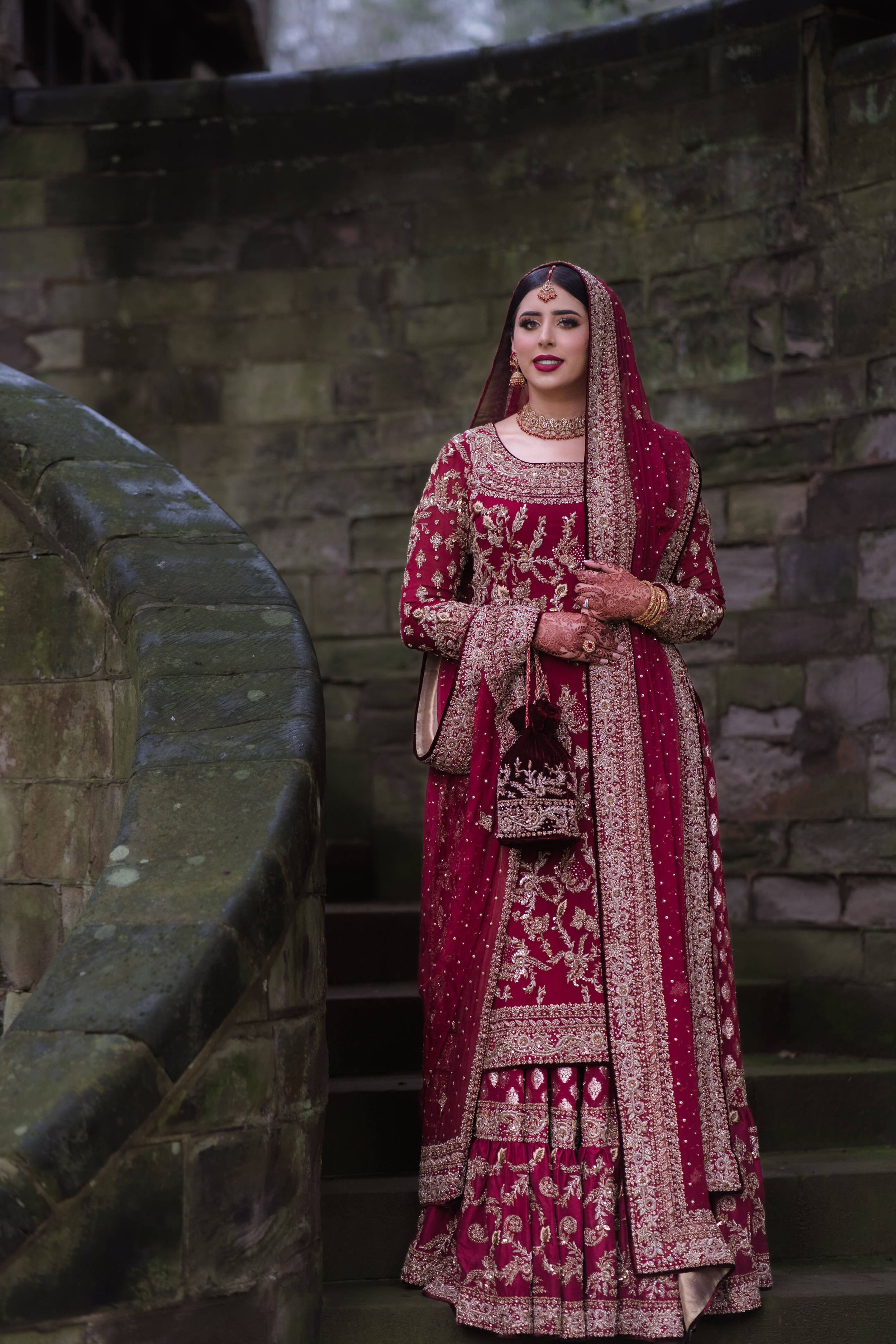 newly wedded wife standing on brick stairs, hopelessly staring into the photographers camera