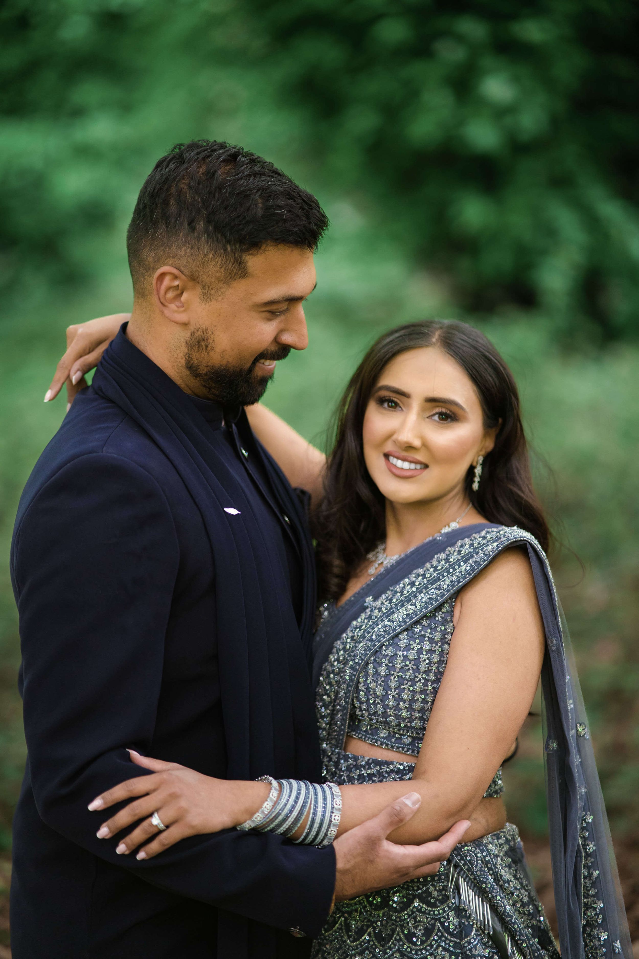 hopelessly devoted couple smiling after their Anand karaj, posing infront of the photographer