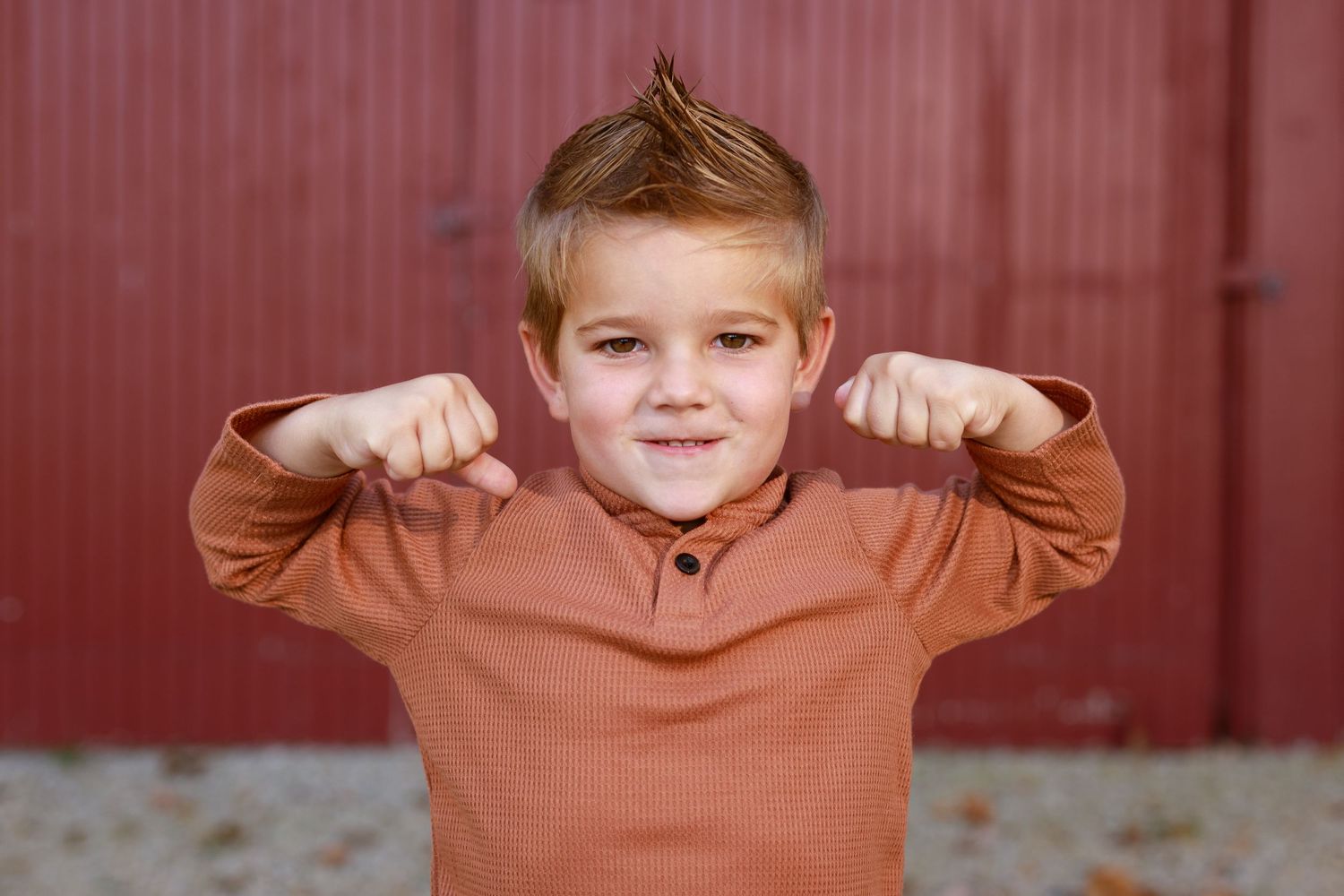 Little man shows off his muscles.