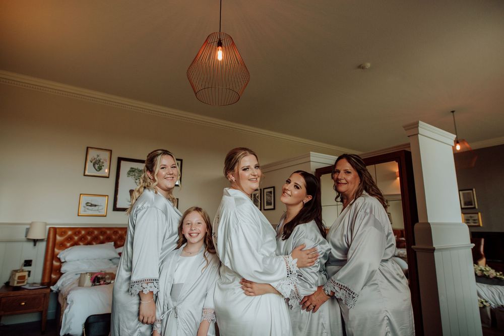 A sequence of wedding preparation photos showing bridesmaids in white robes getting ready for a celebration.
