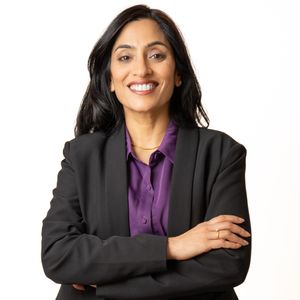 Business professional headshot with confident expression and studio lighting