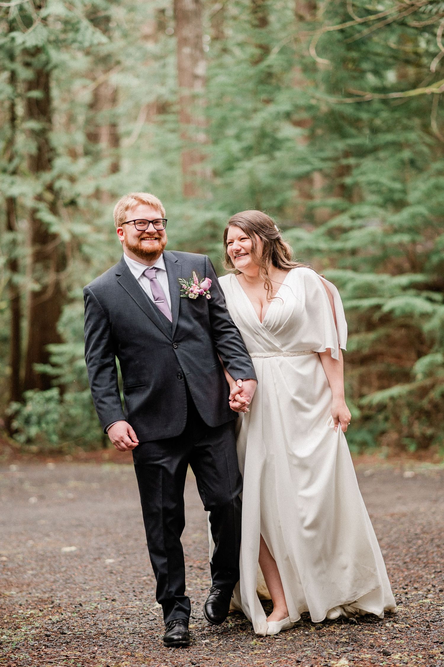 bride and groom laughing and walking holding hands. photo by Pine + Vow