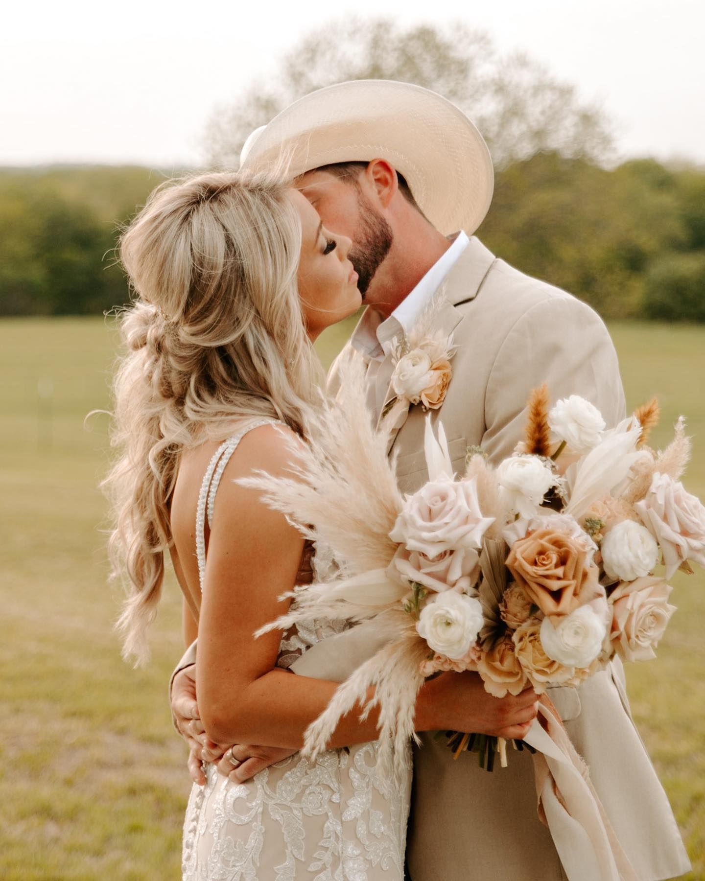 Elegant wedding bouquet featuring pampas grass and peach roses against natural backdrop. Oklahoma Wedding Photographer