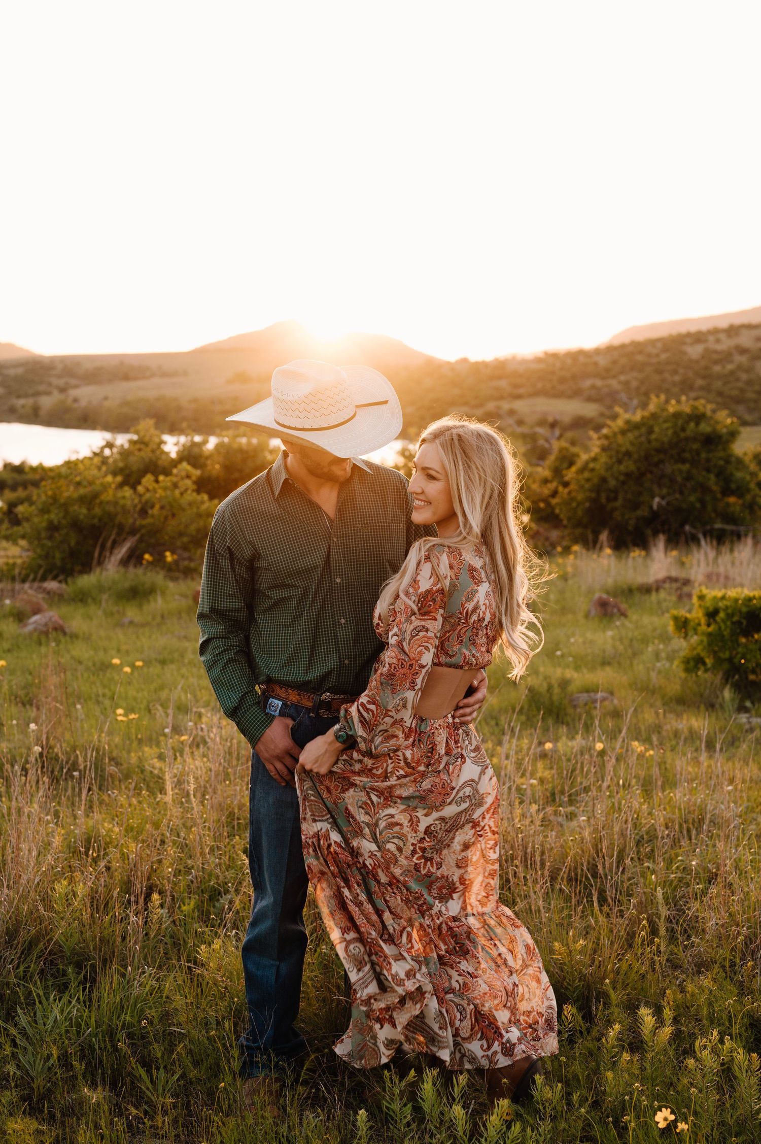 Romantic couple dancing in rustic field during golden hour. Oklahoma Wedding Photographer