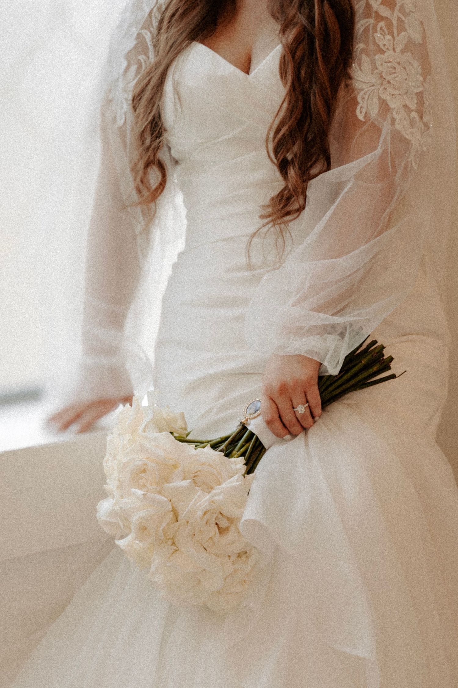 Close-up of bride in white wedding dress holding elegant white bouquet. Oklahoma Wedding Photographer