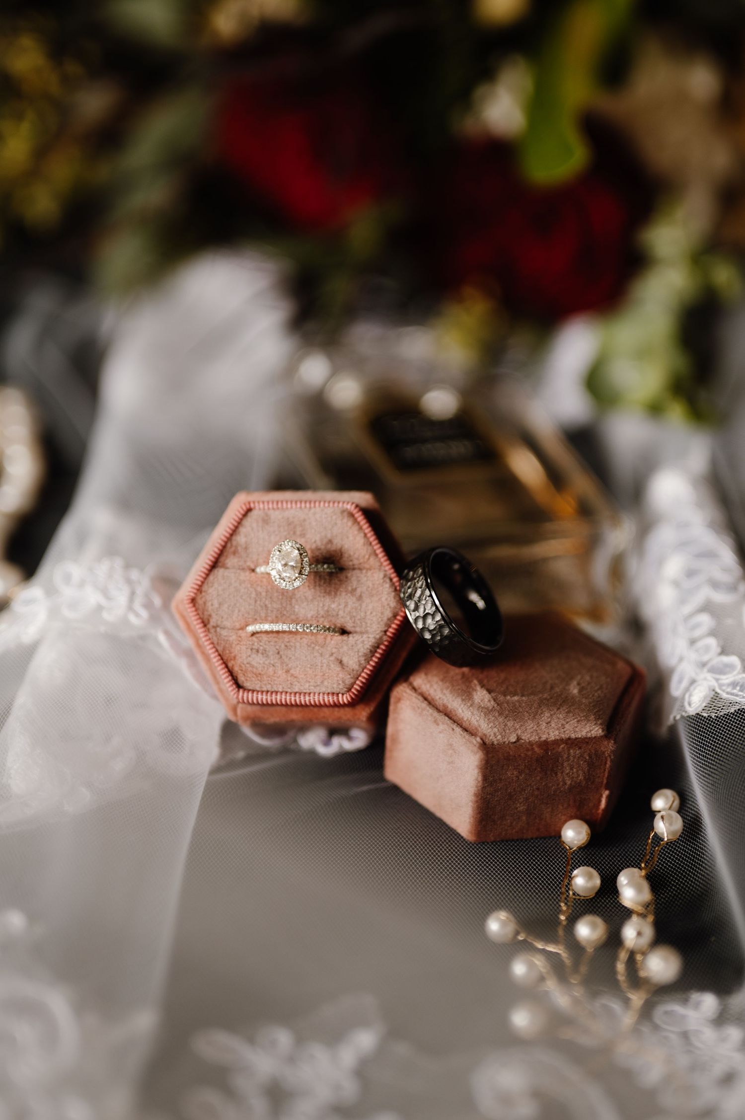 Close-up of hexagonal pink velvet ring boxes with delicate pearl decorations. Oklahoma Wedding Photographer