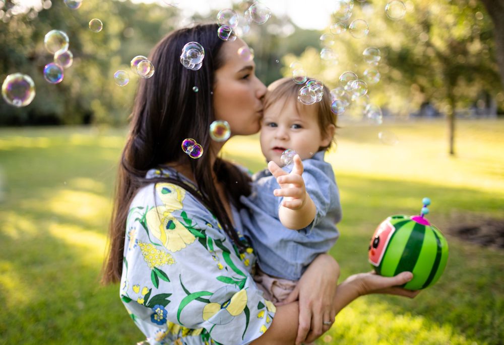 A magical moment outdoors with bubbles floating through the air on a sunny afternoon.