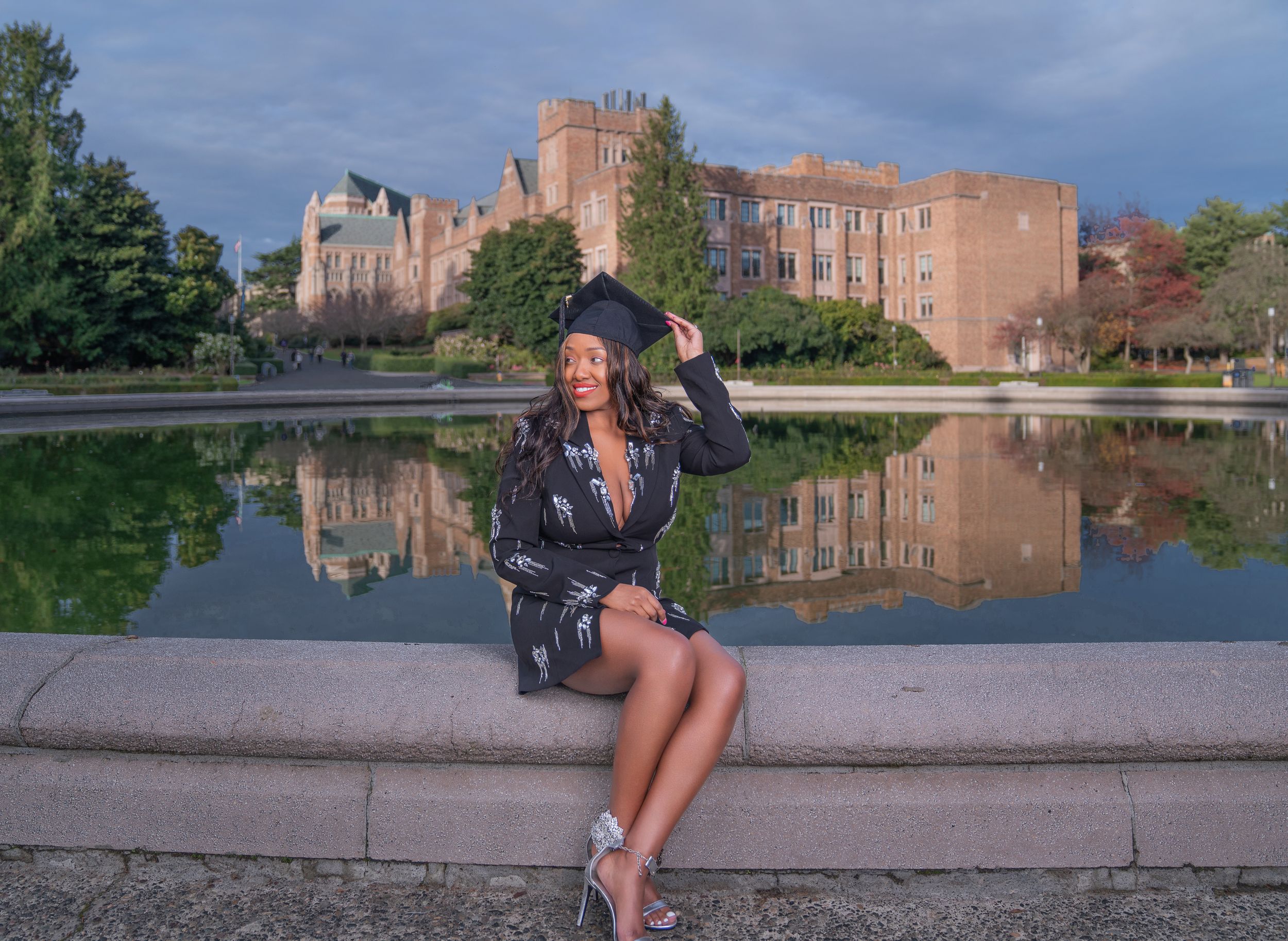 A series of photos showing a person posing in front of a large brick university building near a reflecting pool.