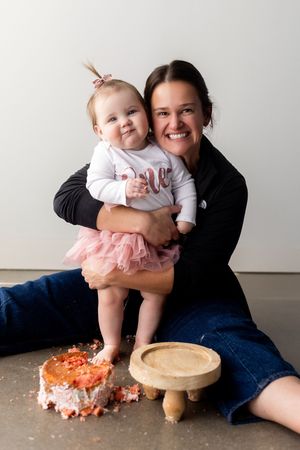A series of photos showing a baby's first birthday cake smash session with increasing cake mess and playful moments.