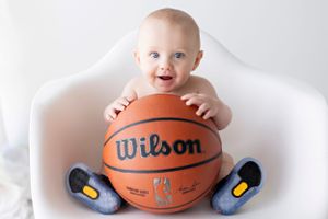 Baby milestone photos with basketball showing sports theme on white background.