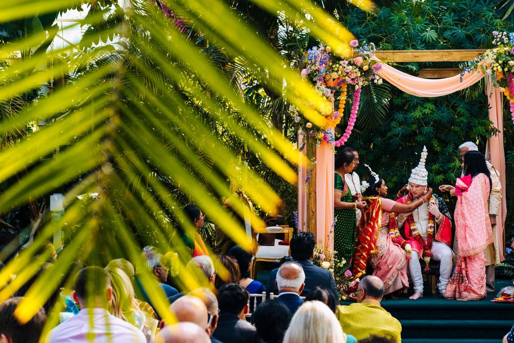 Bride and groom saying wedding vows under mendap inside the palm house in sefton park