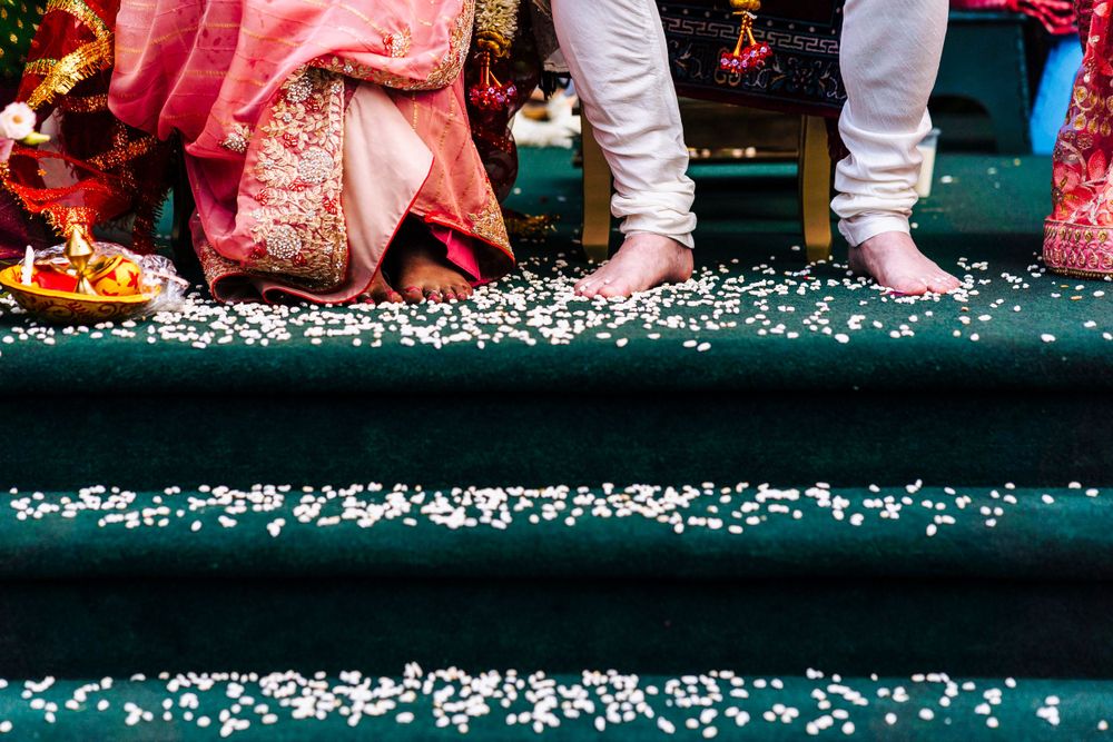 Indian wedding ceremony, throwing rice at the newlyweds,  is a symbolic gesture signifying blessing - pictured is rice at the couples feet