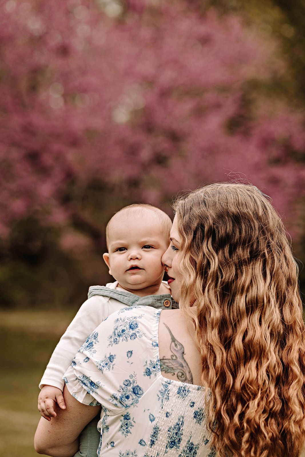 A photograph of a mother and son outdoors in a field of trees and flowers in a casual lifestyle moment in Harford County PA.
