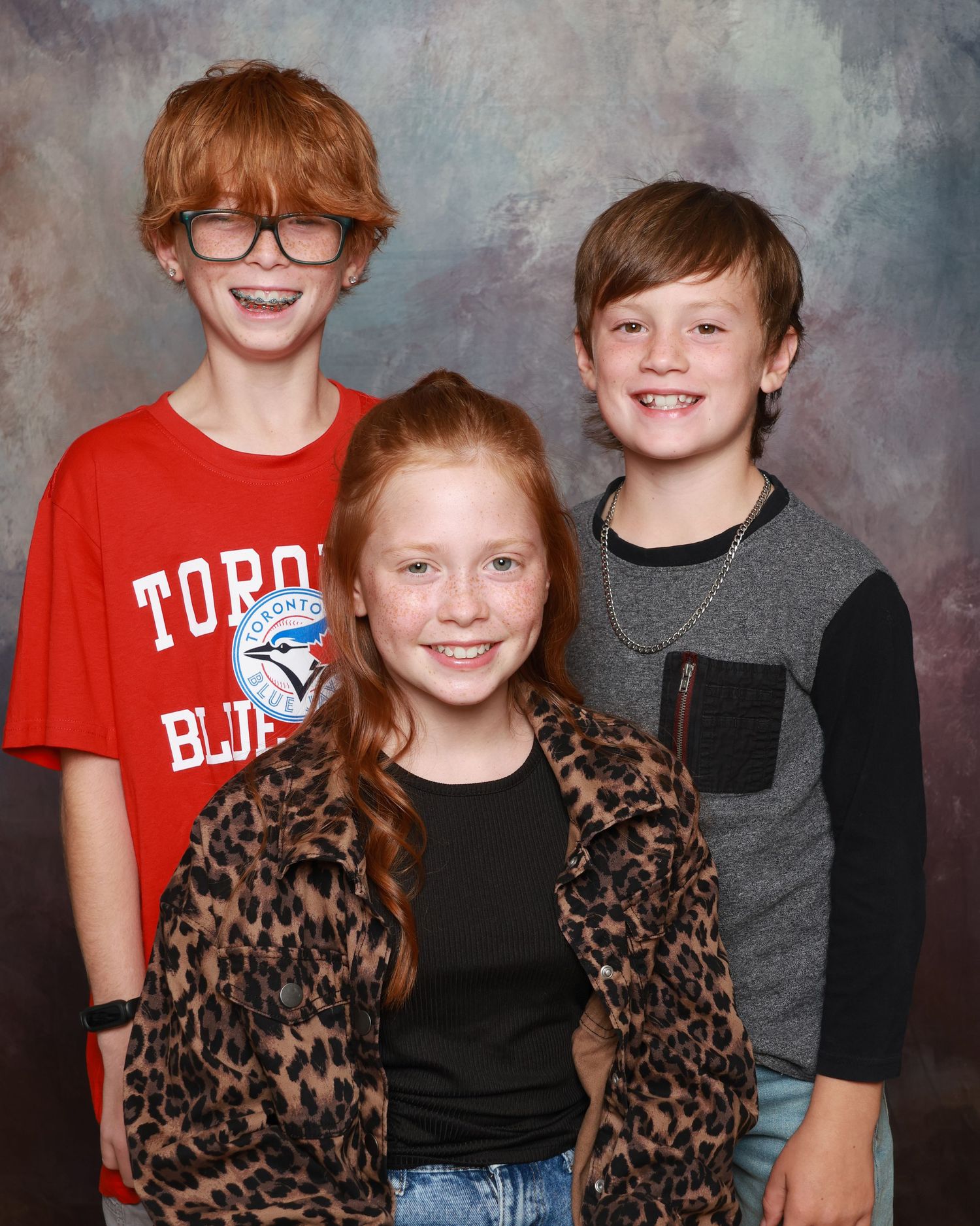 Children smiling naturally during school photo session in Miramichi studio