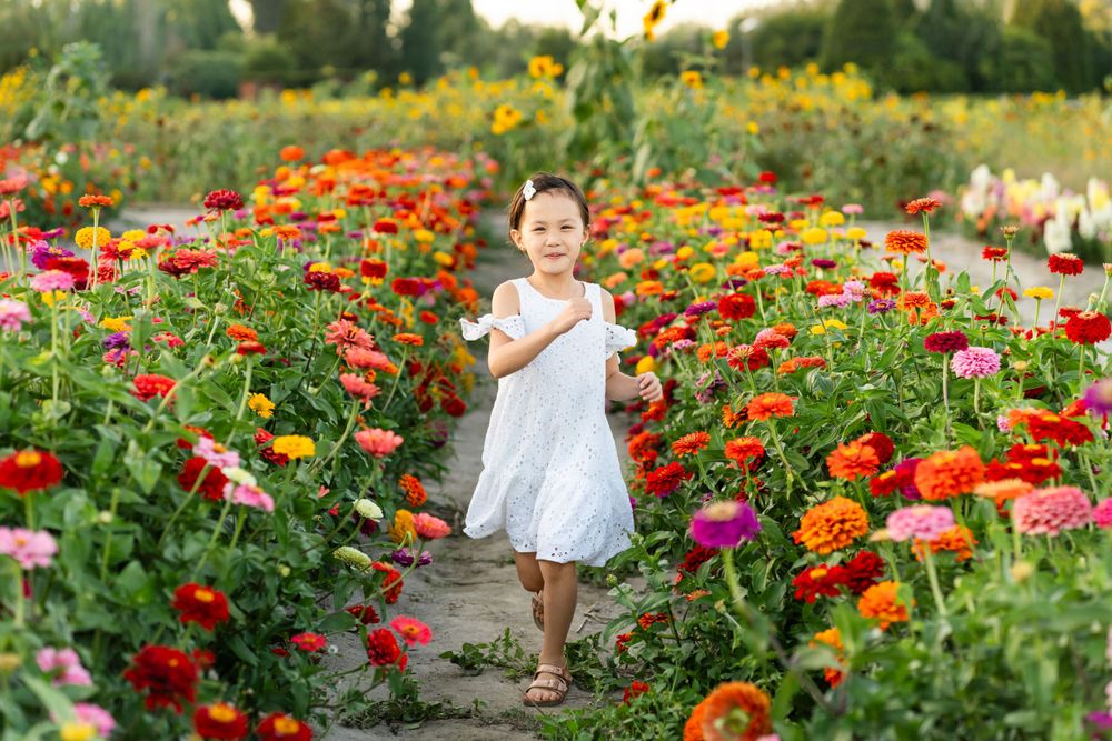 Girl running through a flower field while smiling in Woodinville.