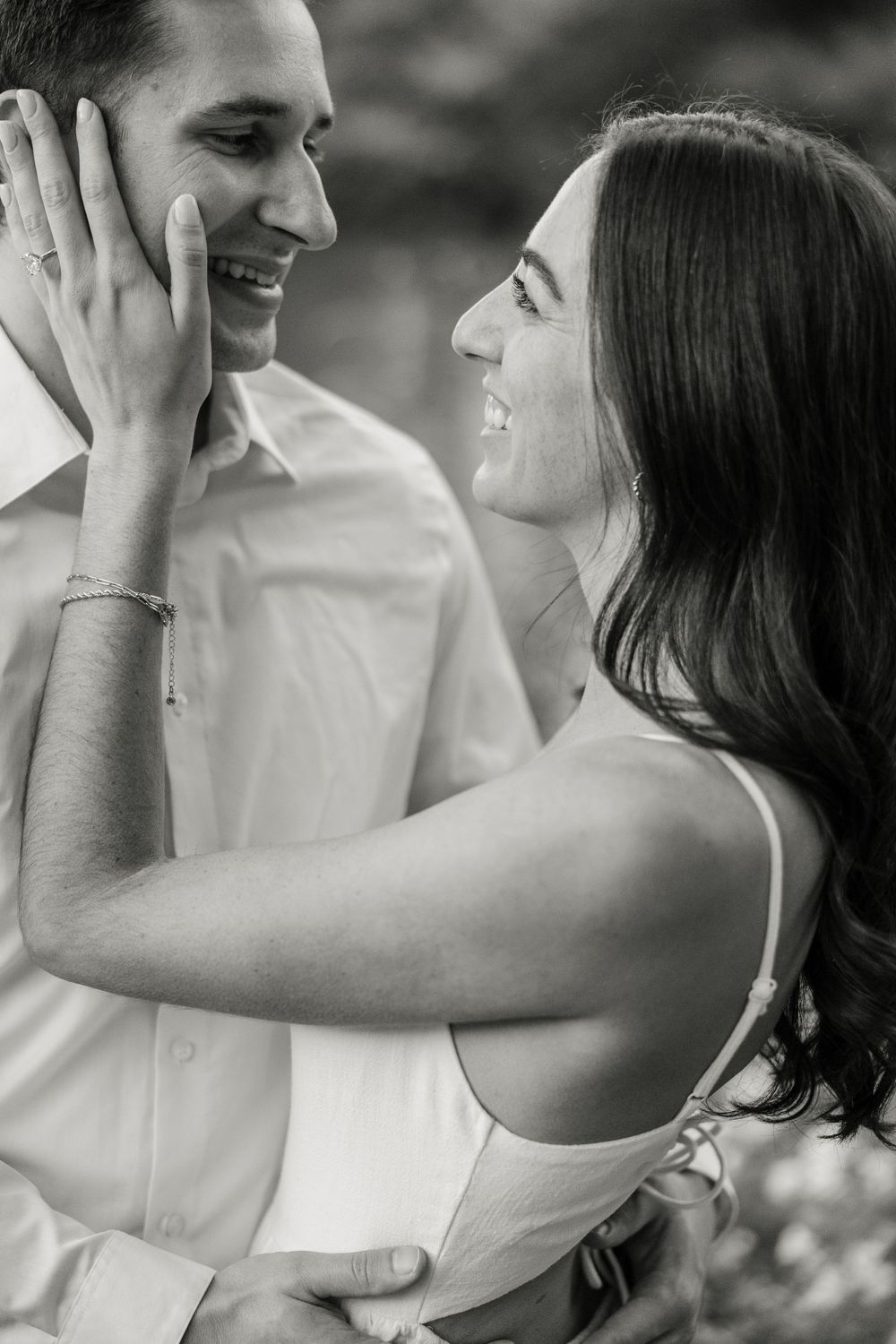 A tender black and white portrait of a couple sharing an intimate romantic moment.