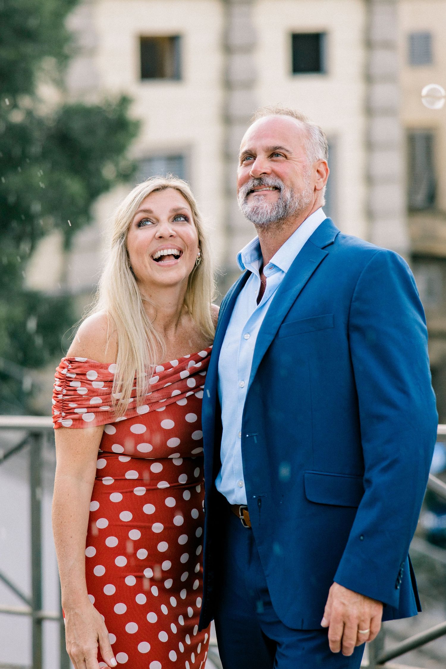 A man and a woman standing next to each other smiling.