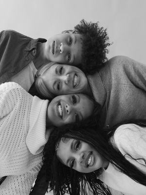 A black and white photo collage shows four candid selfie-style shots capturing joyful expressions and casual moments.