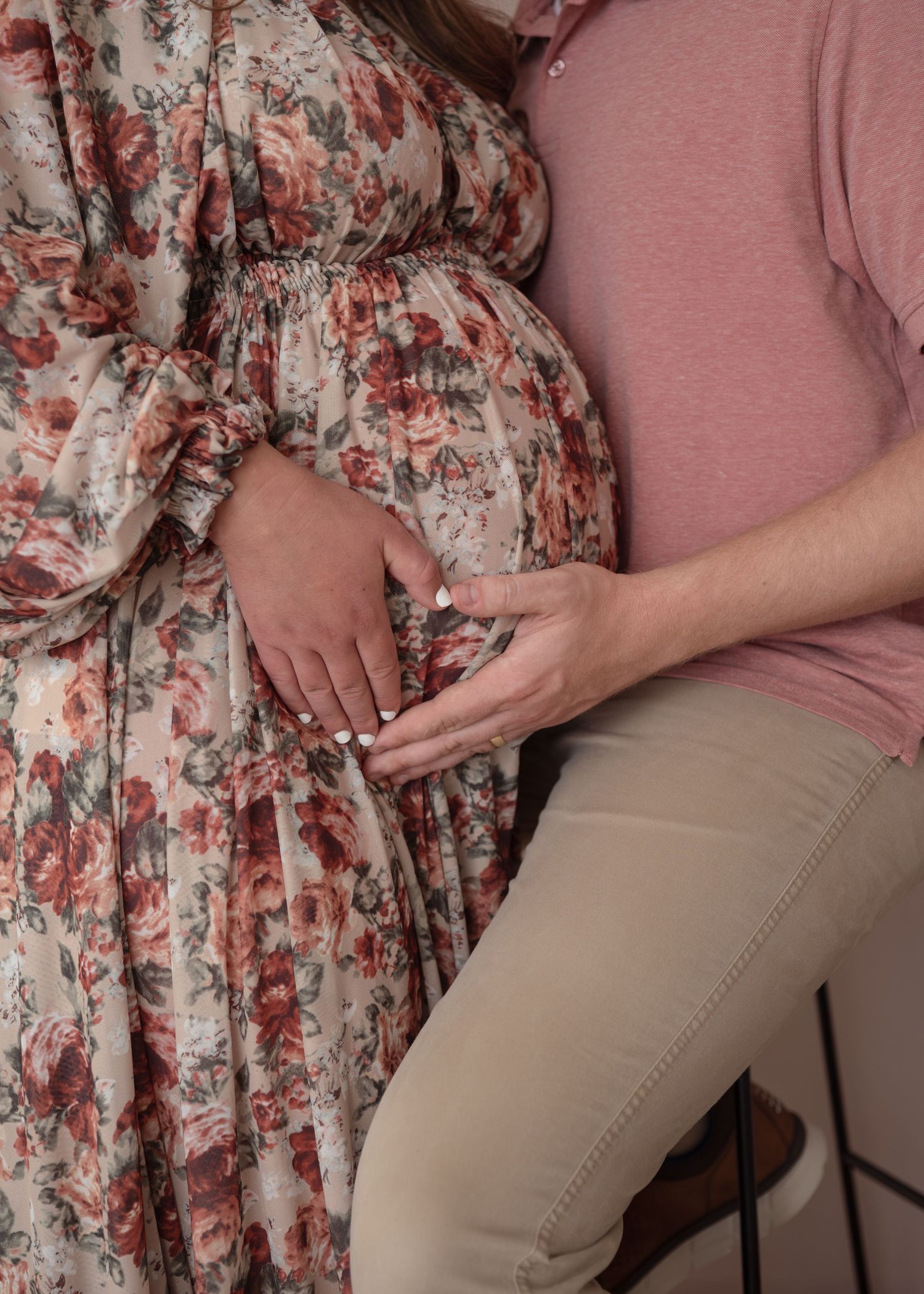 A maternity session close up with mother and father's hand on bump in the shape of a heart. Wrightstown New Jersey Family Photographer