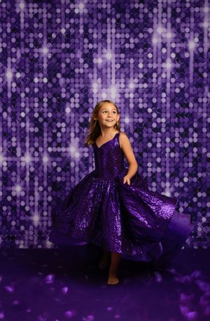 Child in a sparkly purple dress poses against a glittering purple backdrop in a series of connected photos.
