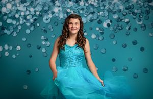 A panoramic collage of a person twirling in a flowing turquoise blue dress against a sparkly bokeh background.