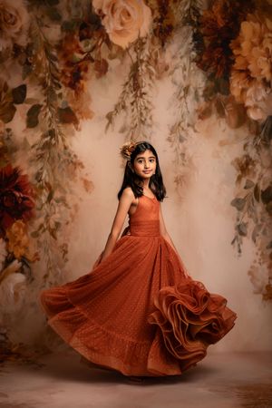 A sequence of photos showing a flowing rust-colored dress in motion against a romantic floral backdrop.