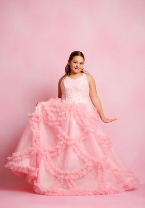 Young girl in a pink ruffle ball gown with lace bodice, posing against a pink background.