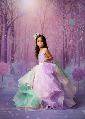 Enchanting portrait series in a dreamy purple forest setting with flowing pastel tulle gowns creating magical atmosphere.