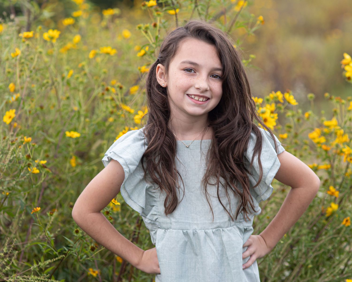A series of outdoor portraits in a field of yellow wildflowers.