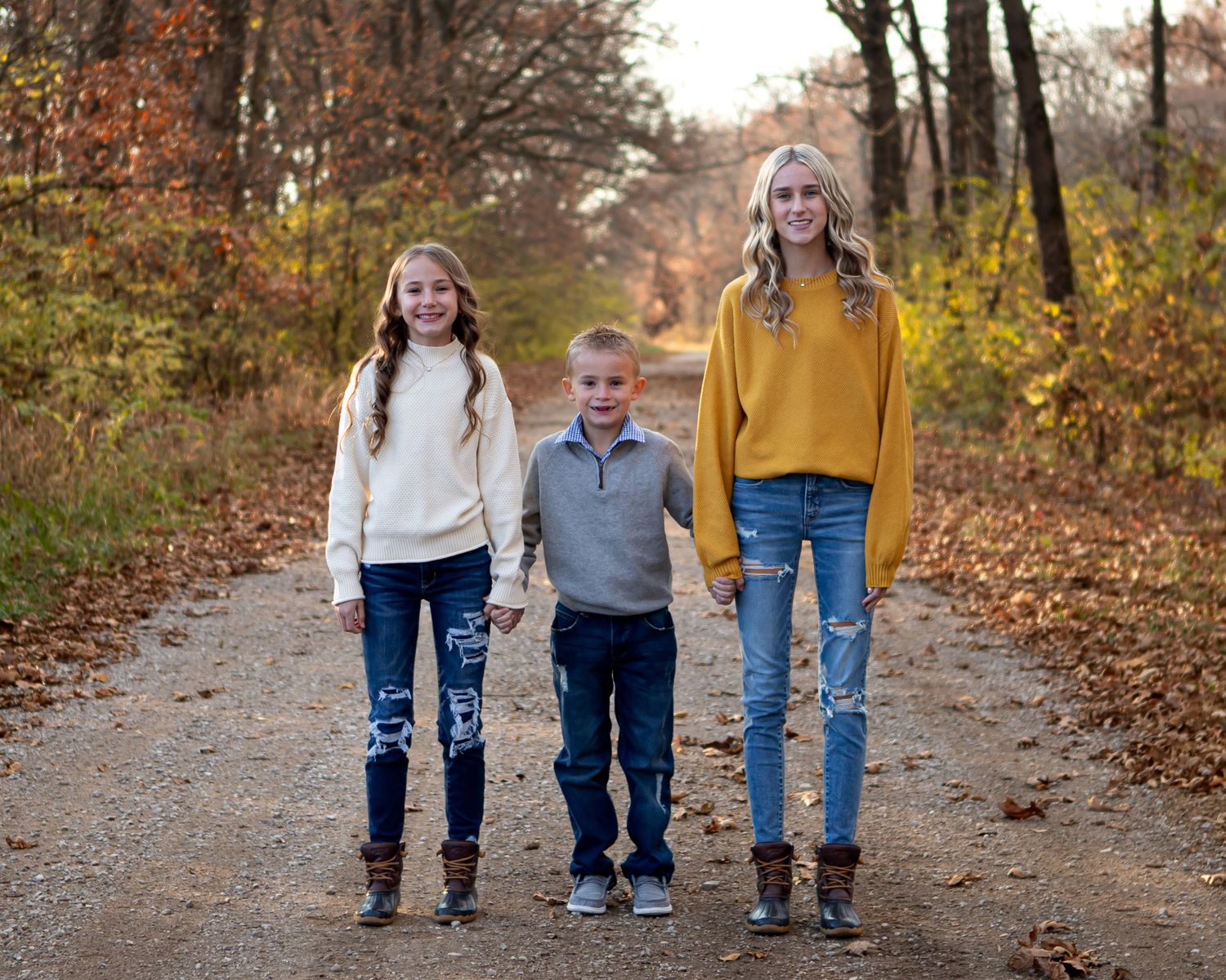 Candid walking shots of families on leaf-covered autumn path.