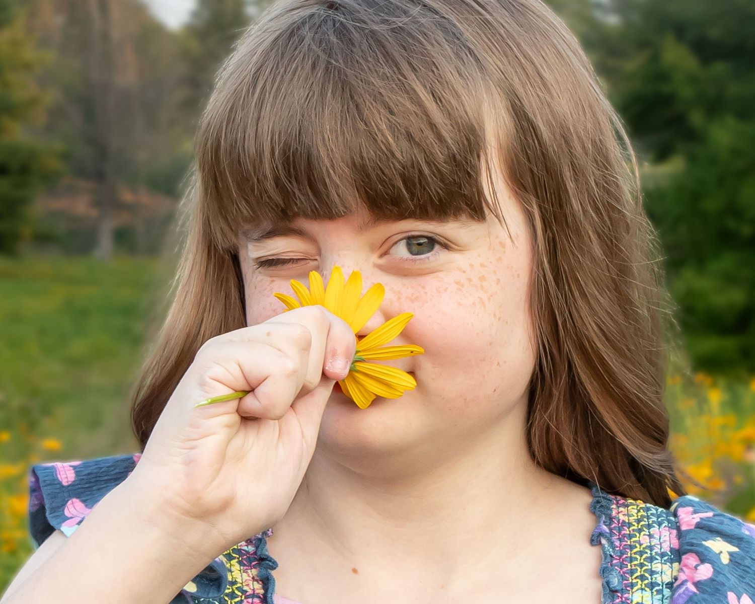 Creative portrait series showing yellow flower held against nose in multiple poses.
