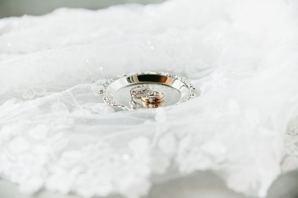 Wedding rings nestled in delicate white lace fabric.