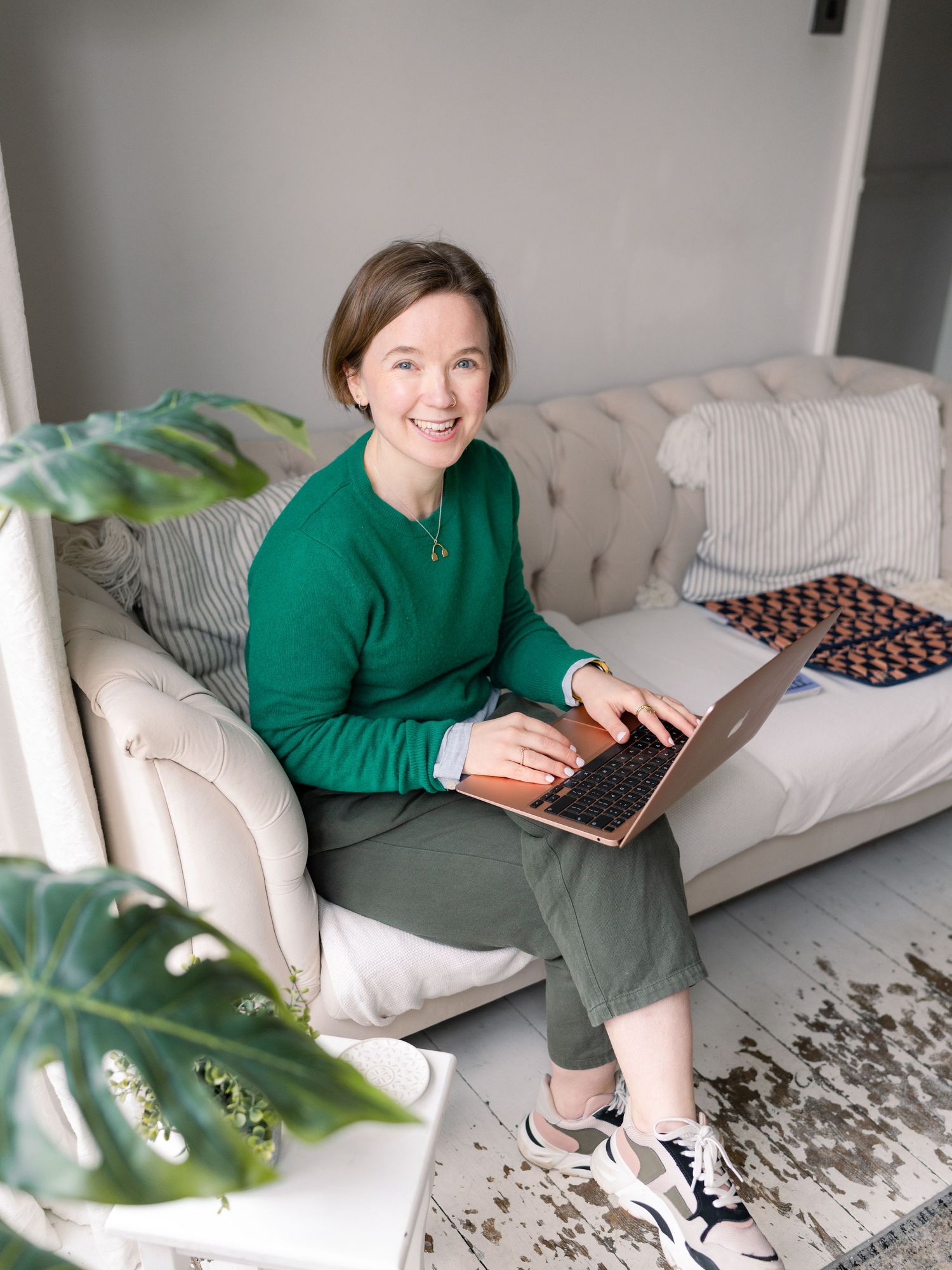 Woman writing in notebook and laughing for relaxed fun headshot at location in Kent