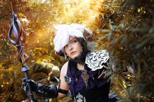 Cosplay session dramatic lighting at Bok Tower Gardens. Golden light cinematic poses of Final Fantasy 14 character with staff prop