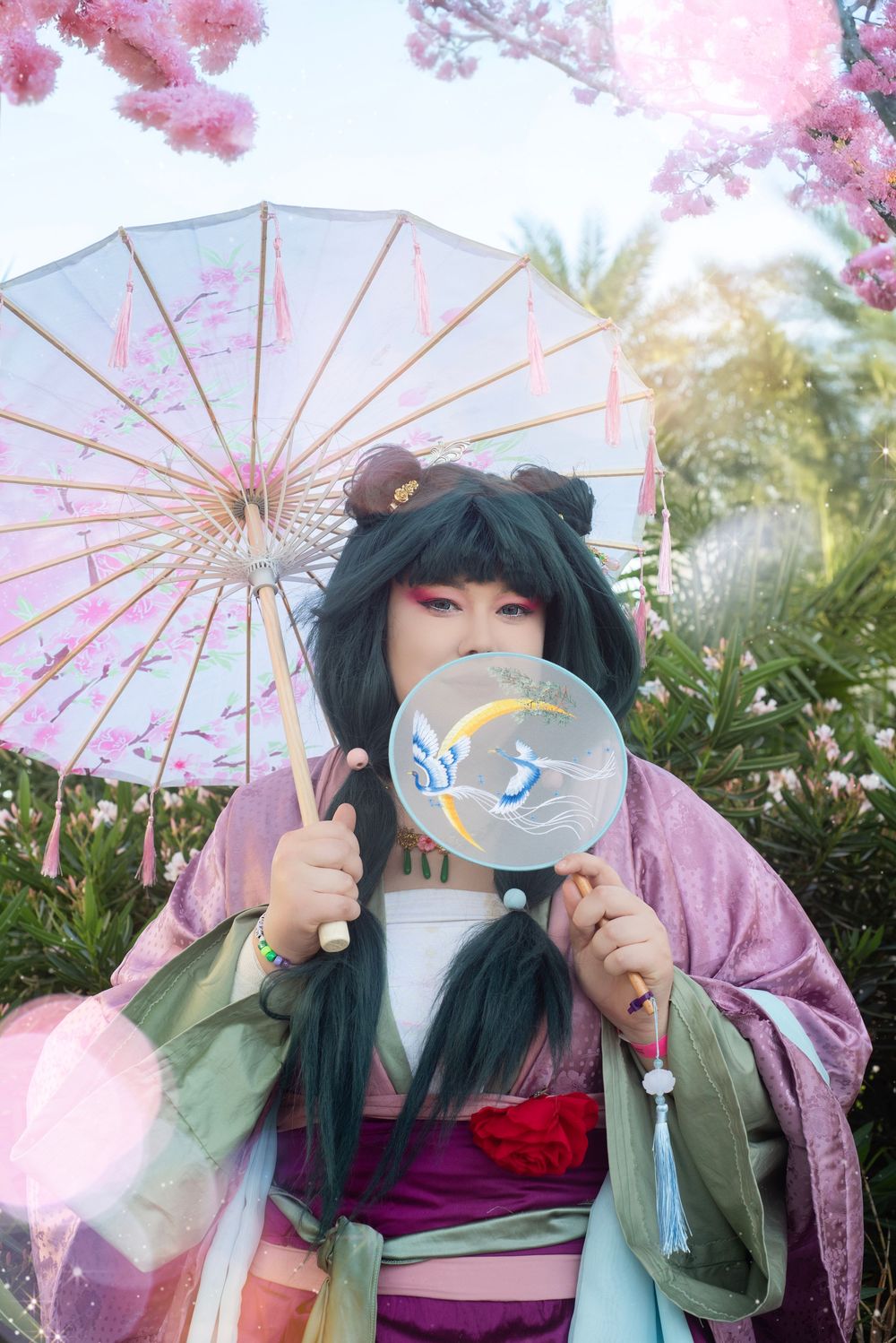 Cosplay photography at Holiday Matsuri showcasing dynamic character pose with fan prop
