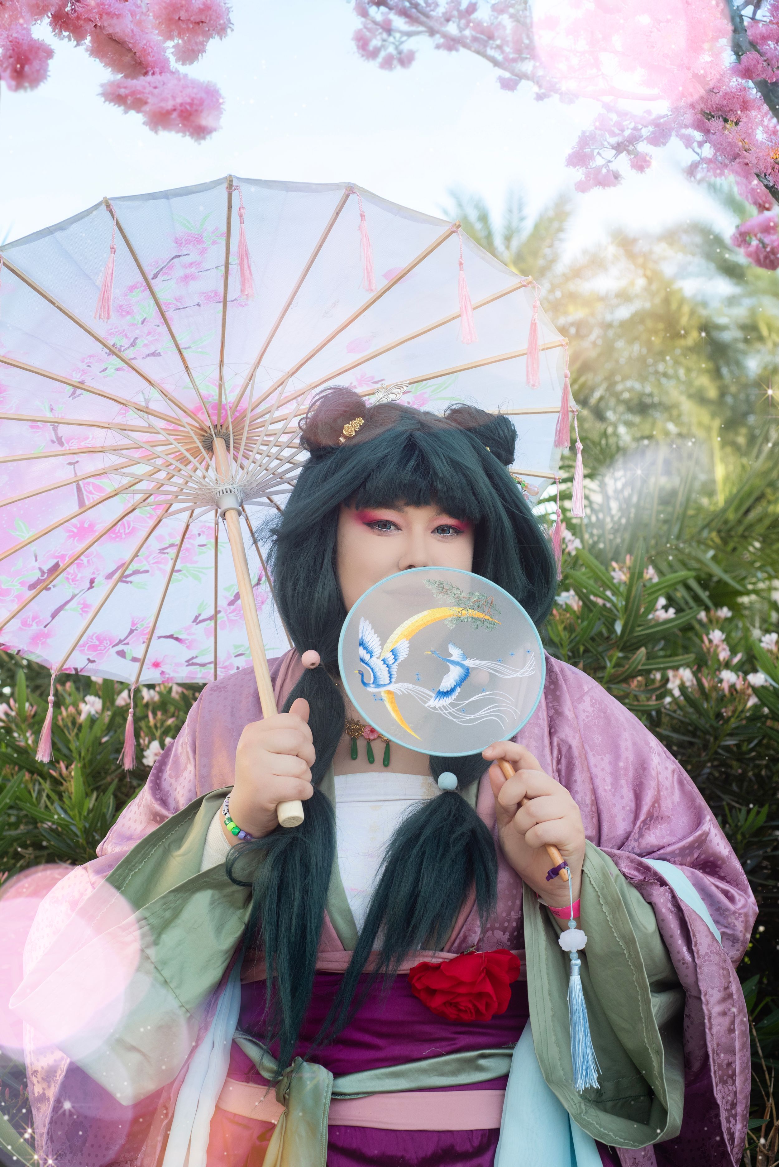 Cosplay photography at Holiday Matsuri showcasing dynamic character pose with fan prop