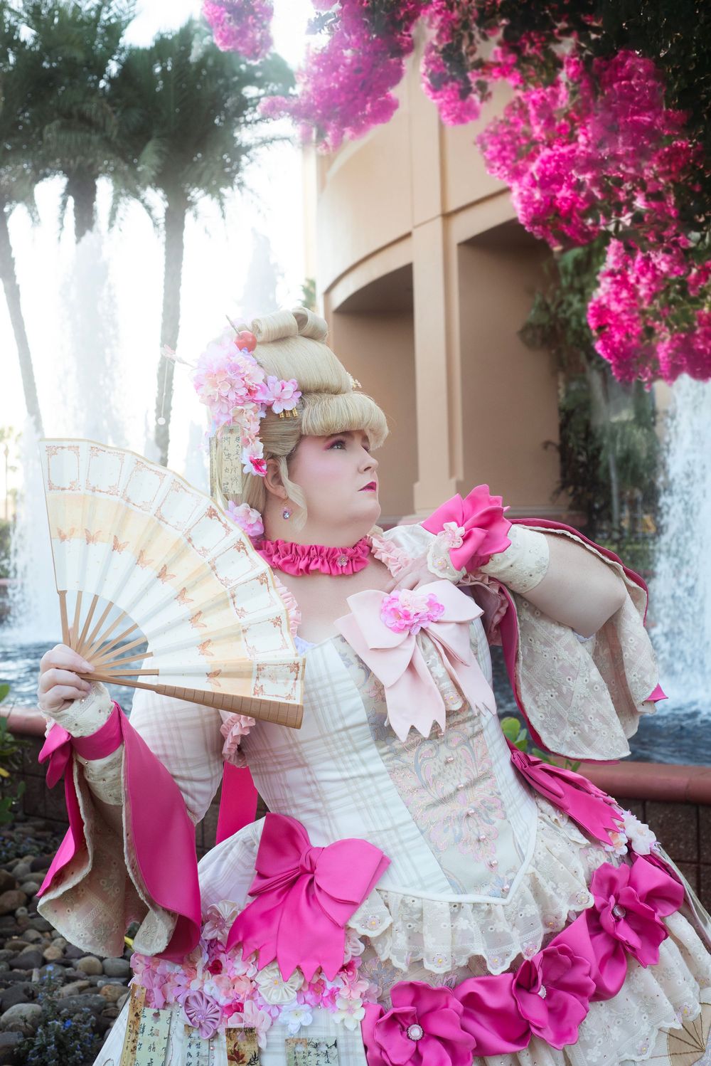Cosplay photography at Holiday Matsuri showcasing dynamic character pose with fan prop