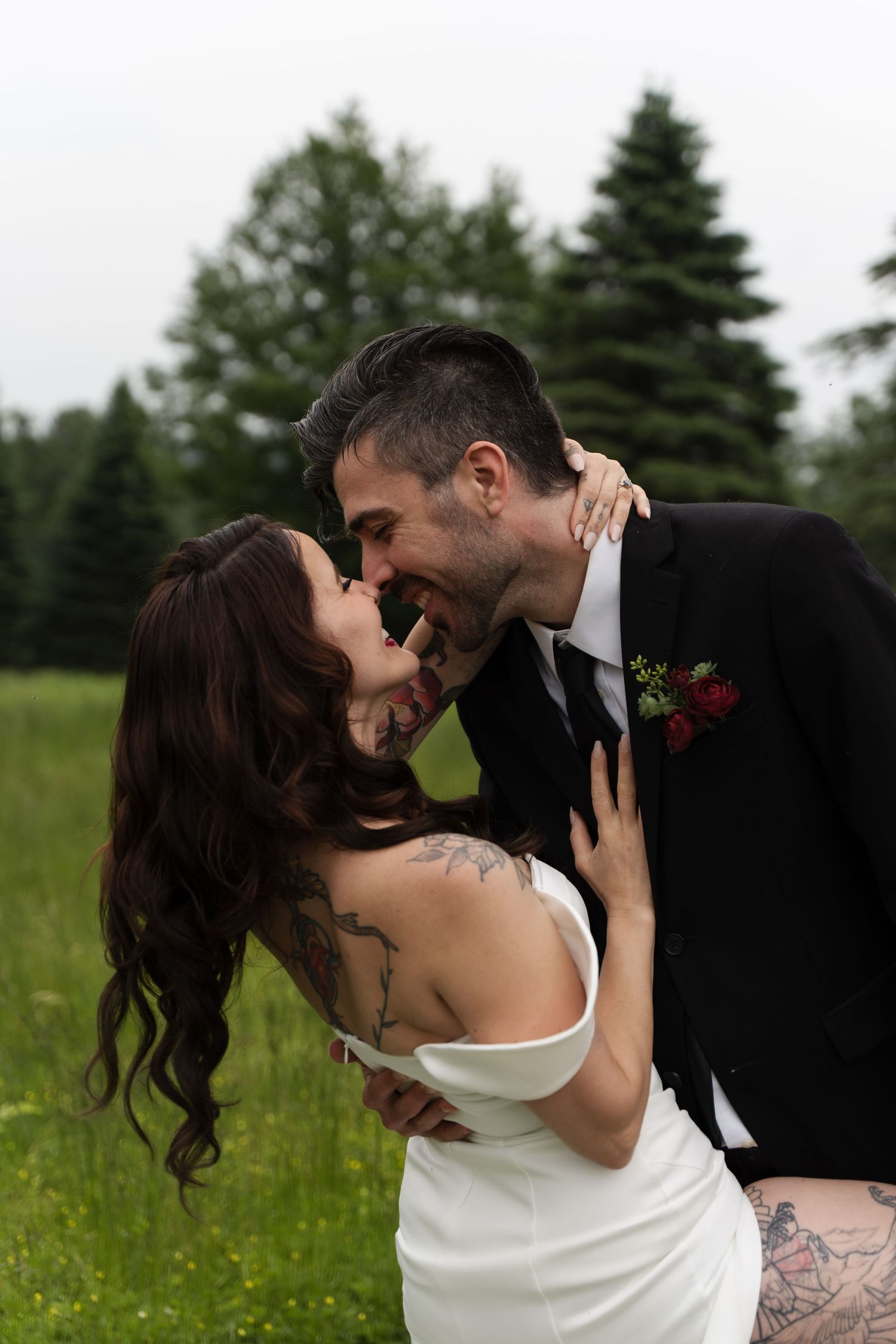 Romantic wedding couple embracing in a field of wildflowers.
