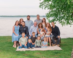 A series of outdoor family portraits taken by a lake with natural lighting and scenic waterfront views in the background.