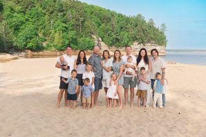 A panoramic series of beach group photos with people posing together on a sandy shoreline.
