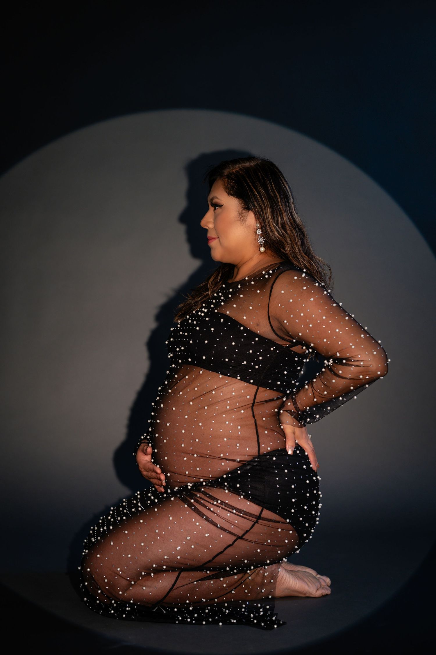 Artistic boudoir sequence with sheer polka dot dress in dark setting.
